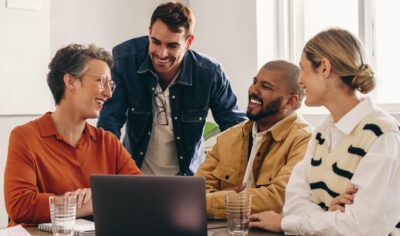 DEI at work: Diverse team working happily together.